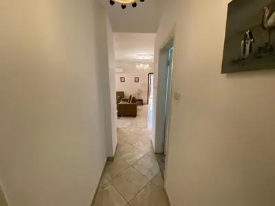 a hallway leading to a living room with a couch at ROYAL Real ESTATE in Amman