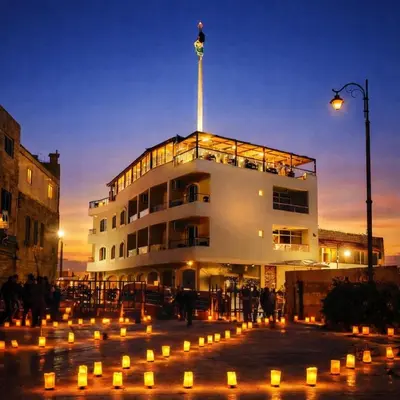 a building with candles in front of it at night at Saint John Hotel in Madaba