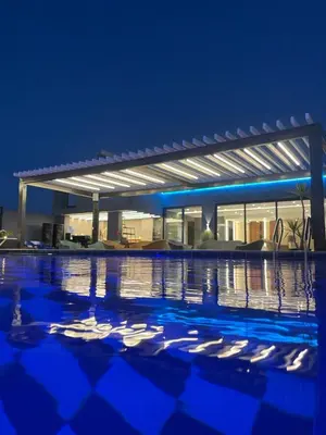 a view of a swimming pool at night at Mass Paradise Hotel in Aqaba