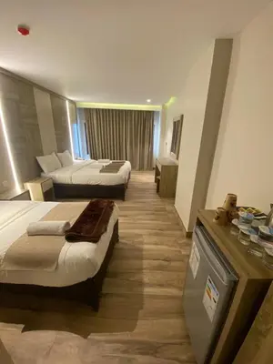 a hotel room with two beds in a room at Mass Paradise Hotel in Aqaba