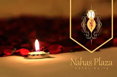 a candle with a picture of a hotel suite at Nahas Plaza in Irbid