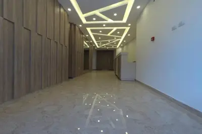 a hallway of a building with lights on the ceiling at Amazing one Bedroom Apartment in Amman Elwebdah 8 in Amman