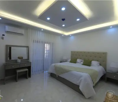a bedroom with a bed and a television and a bed sidx sidx sidx at Amazing one Bedroom Apartment in Amman Elwebdah 8 in Amman