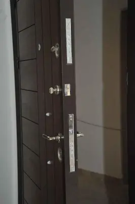 a wooden door with a mirror in a room at Amazing one Bedroom Apartment in Amman Elwebdah 2 in Amman