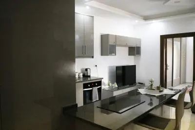 a kitchen with a black counter top in a room at Amazing one Bedroom Apartment in Amman Elwebdah 5 in Amman