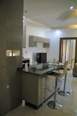 a kitchen with a counter and two bar stools at Amazing one Bedroom Apartment in Amman Elwebdah 5 in Amman