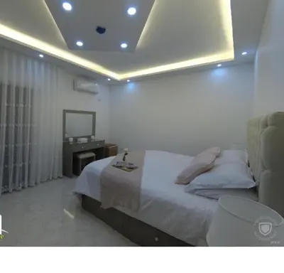 a bedroom with a bed and a television in a room at Amazing one Bedroom Apartment in Amman Elwebdah 1 in Amman