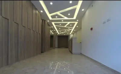 a hallway with wooden walls and a ceiling with lights at Amazing one Bedroom Apartment in Amman Elwebdah 1 in Amman