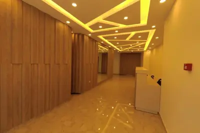 a hallway with wooden walls and ceilings with lights at Amazing one Bedroom Apartment in Amman Elwebdah 4 in Amman