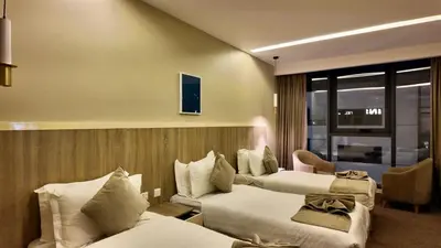 a hotel room with two beds and a window at Twins Boutique Hotel in Aqaba