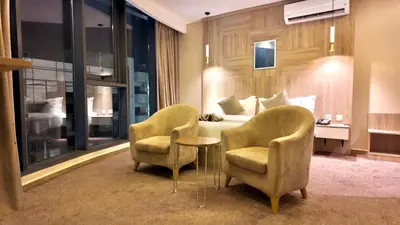 a hotel room with two chairs and a bed at Twins Boutique Hotel in Aqaba