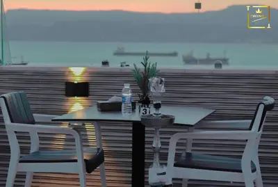 a table and chairs with a view of the ocean at Twins Boutique Hotel in Aqaba