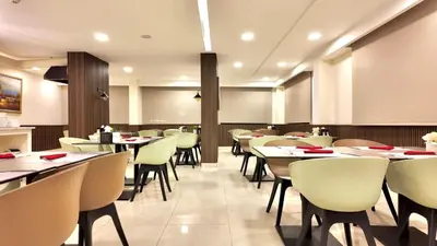 a dining room with tables and chairs in a restaurant at Twins Boutique Hotel in Aqaba