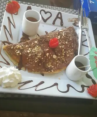 a plate of food with chocolate and nuts on it at Seven Days Hotel in Irbid