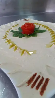 a white cake with a red rose on top at Seven Days Hotel in Irbid