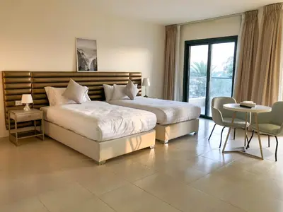 a bedroom with a large bed and a table and chairs at Sea view hotel in Aqaba