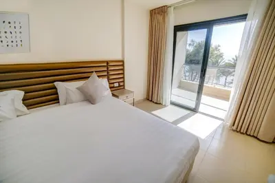 a bedroom with a large bed and a large window at Sea view hotel in Aqaba