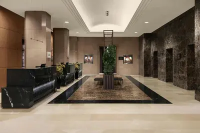 a lobby of a hotel with a plant in the center at Sheraton Amman Al Nabil Hotel in Amman