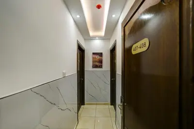 a hallway with a door and a sign on a wall at Downtown Hotel للعائلات فقط in Aqaba