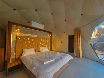 a bedroom with a large bed in a tent at Luxury Color Camp in Wadi Rum