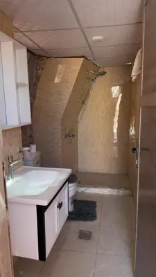 a bathroom with a sink and a shower and a toilet at Luxury Desert & Bedouin Adventure in Wadi Rum