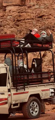 a group of people riding in the back of a truck at Luxury Desert & Bedouin Adventure in Wadi Rum