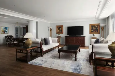 a living room with a couch and a tv at Dead Sea Marriott Resort & Spa in Sowayma