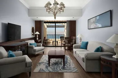 a living room with a couch and chairs and a table at Dead Sea Marriott Resort & Spa in Sowayma