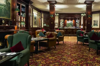 a restaurant with tables and chairs and a bar at Amman Marriott Hotel in Amman