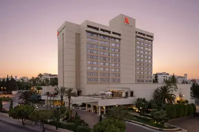 a large white building with a m hotel at Amman Marriott Hotel in Amman