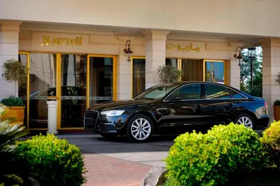 a black car parked in front of a store at Amman Marriott Hotel in Amman