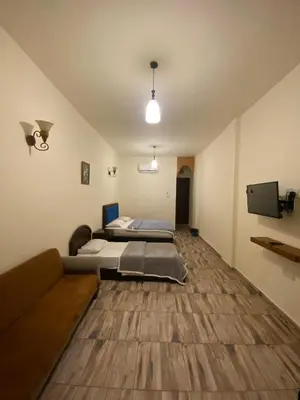a room with a bed and a couch in it at Bait Alaqaba dive center & resort in Aqaba