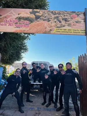 a group of people in wet suits standing in front of a truck at Bait Alaqaba dive center & resort in Aqaba