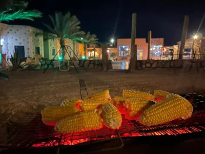 a bunch of corn on the grill at night at Bait Alaqaba dive center & resort in Aqaba