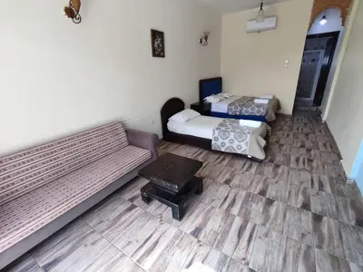 a living room with two beds and a couch at Bait Alaqaba dive center & resort in Aqaba