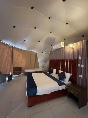 a bedroom with two beds in a tent at Bubbles Desert Camp Jeep Tours in Wadi Rum