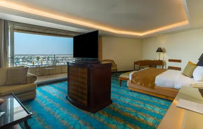 a hotel room with a bed and a large window at Le Royal Hotel - Amman in Amman