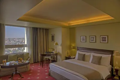 a hotel room with a bed and a window at Le Royal Hotel - Amman in Amman