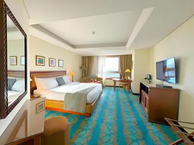 a hotel room with a bed and a television at Le Royal Hotel - Amman in Amman