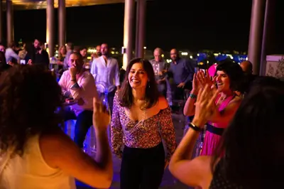 a group of people dancing at a party at Centro Mada Amman by Rotana in Amman