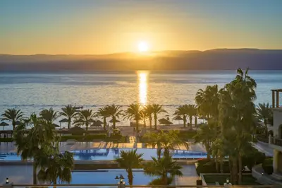 a view of the ocean from a resort at sunset at Grand Tala Bay Resort, Aqaba in Aqaba