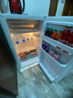 an open refrigerator filled with drinks and sodas at Omar Apartment in Wadi Musa
