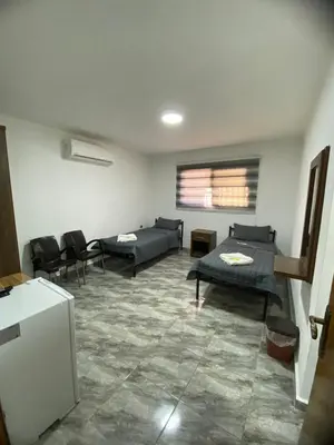 a living room with couches and chairs in a room at Omar Apartment in Wadi Musa