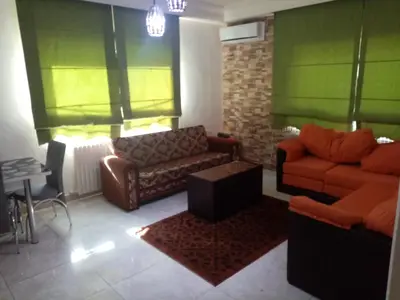 a living room with two couches and a table at الفارس الوسيم للشقق الفندقيه in Amman