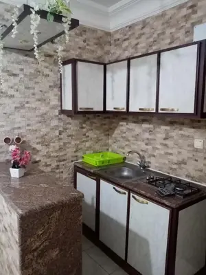 a kitchen with a sink and a counter top at الفارس الوسيم للشقق الفندقيه in Amman