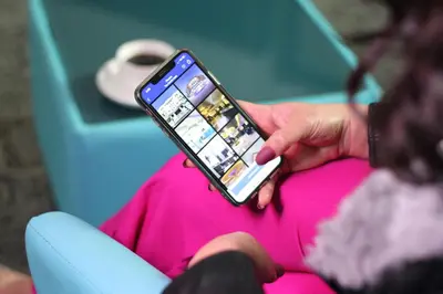 a person holding a cell phone in their hand at The Castle Hotel in Amman