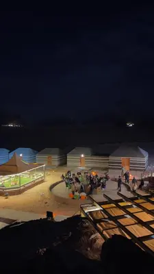 a group of people standing around in a amphitheater at night at Osama Luxury Camp for Camping and Bubbles in Wadi Rum