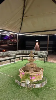 a fountain in the middle of a field of grass at Osama Luxury Camp for Camping and Bubbles in Wadi Rum