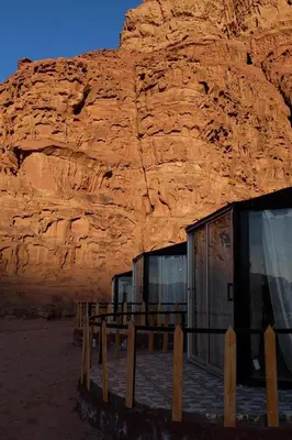 a building in front of a rock wall at joy of life Camp in Wadi Rum