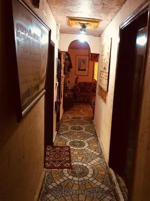 a hallway with a tiled floor in a house at Petra bedouin house in Al Ḩayy